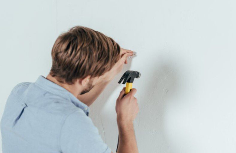 How To Hang Things On Cement Walls Without Drilling Holes